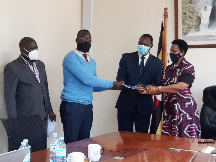 The Permanent Secretary at the Ministry of Tourism, Wildlife and Antiquities, Ms. Doreen S. Katusiime (Right) with the Chief of Party of USAID/Uganda Combating Wildlife Crime Activity Mr. Geoffrey Mwedde (2nd Right), hand the COSEKE Uganda Ltd. Head of Technical Operations, Mr. John David Ocen (2nd Left) a contractual agreement for the development of the e-CITES permit system for Uganda as the Ag. Commissioner of Wildlife Conservation at the Ministry Mr. Candia Leone witnesses.