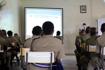 Dr. Simon T. Nampindo delivering the lecture (Left) and interacting with a police officer (Right) at the Police Senior Command and Staff College at Bwebajja in Kampala, Uganda.